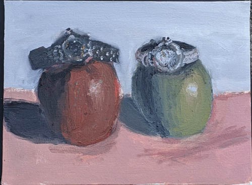 Still life of an apple and a green fruit, each wearing a wristwatch
